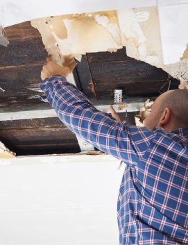 A man repairing leaking roof
